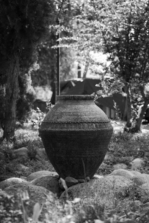 A black and white photo of a large pot