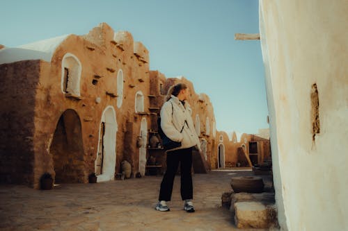 A woman standing in front of a building