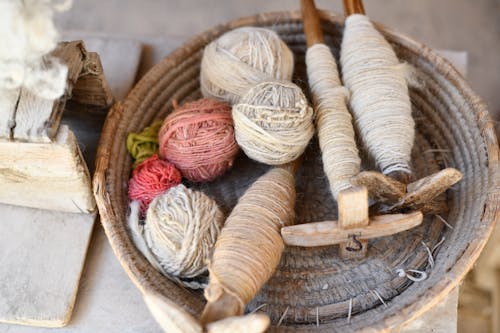 A basket filled with yarn and knitting needles