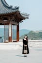 Woman in Black Dress at Temple