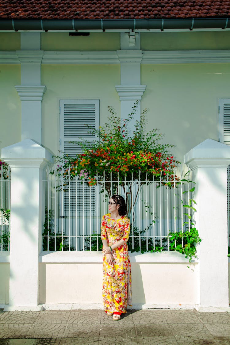 Woman Wearing Colorful Dress In Front Of A Mansion 