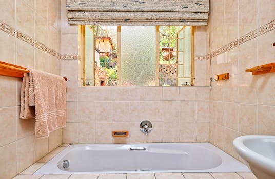 Warm and inviting bathroom with a view of greenery through the window in Pretoria.