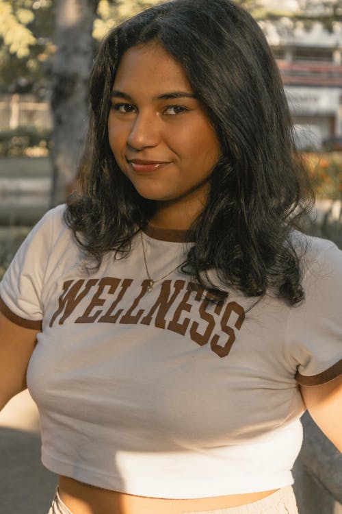 A woman in a crop top and shorts posing for a photo