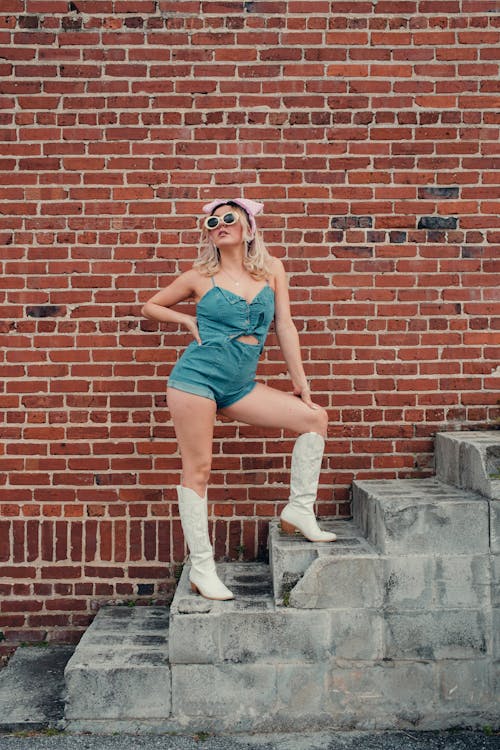 Blonde Woman in Boots Standing on Stairs