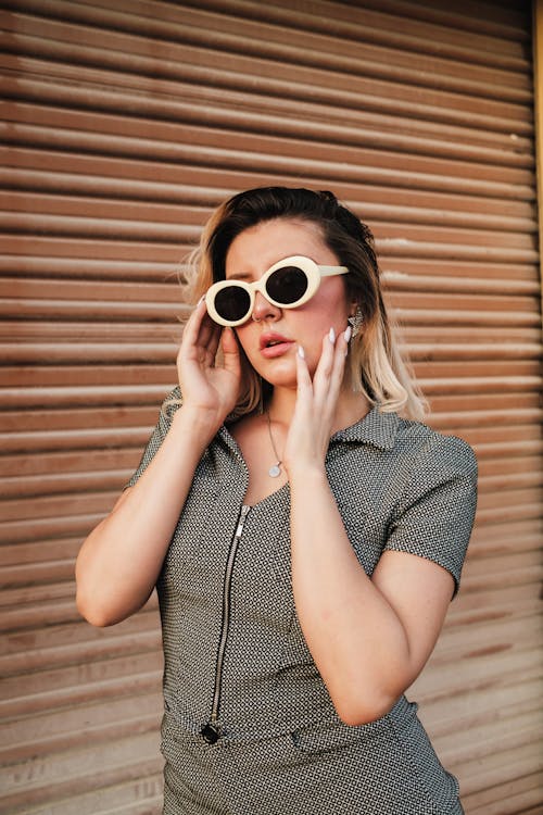 Free A woman in sunglasses and a grey dress Stock Photo