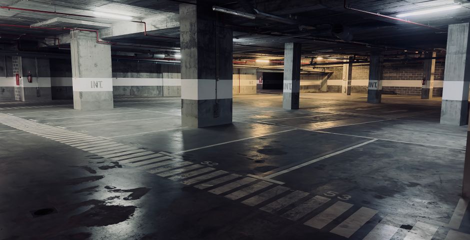 An underground car park — common property covered by the management contract, not private units