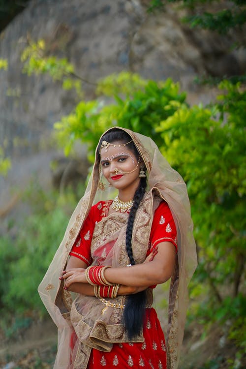 A woman in traditional indian clothing posing for a photo