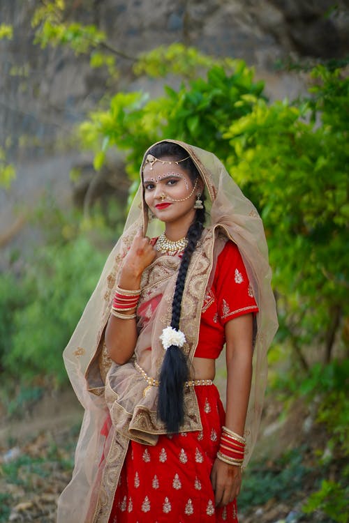 A woman in traditional indian clothing posing for a photo