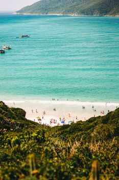 Aerial view of Arraial do Cabo beach with turquoise waters and lush greenery in Rio de Janeiro, Brazil.