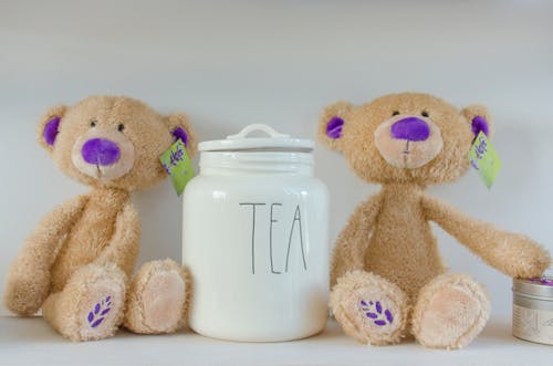 Two Bear Plush Toy Beside Tea Jat