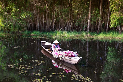 Free Person Riding Brown Boat Stock Photo