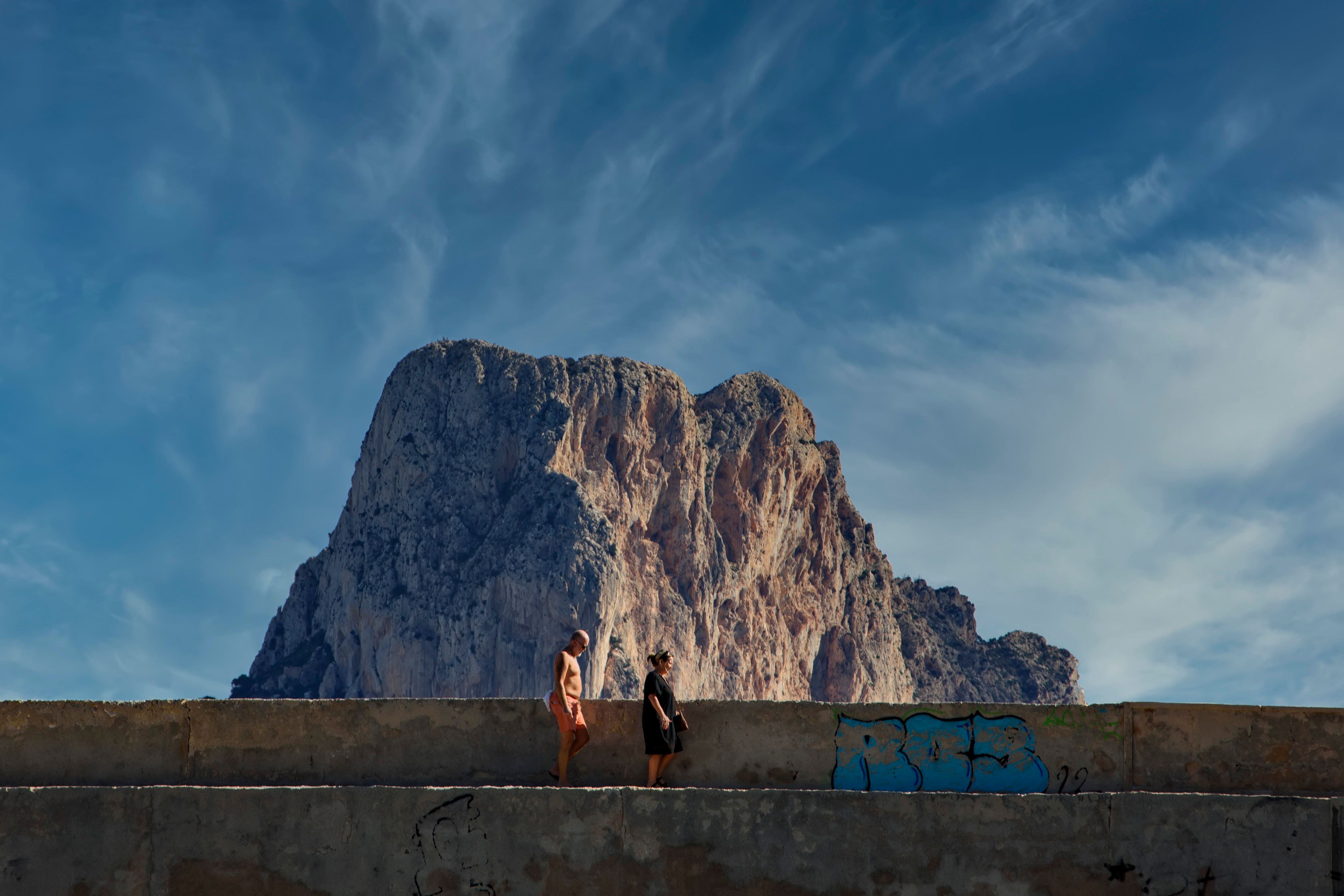 Man and Woman on Concrete Bridge Near Large Rock Formation · Free Stock ...