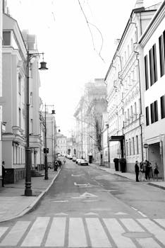 Elegant black and white street scene in Moscow showcasing urban architecture and city life.