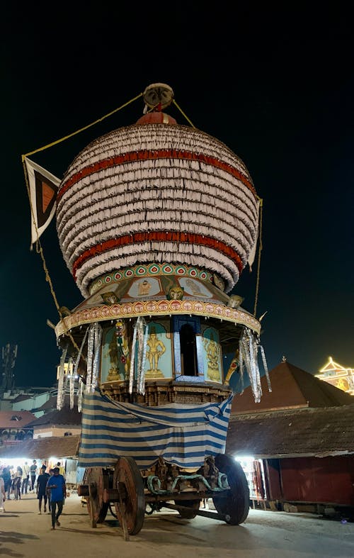 A large decorated boat is parked in front of a building