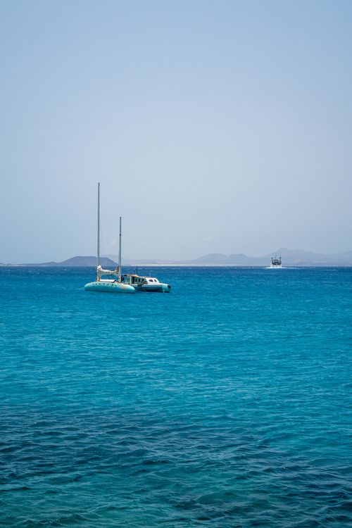 Free A serene view of a catamaran anchored on the turquoise sea near Lanzarote, Spain. Stock Photo