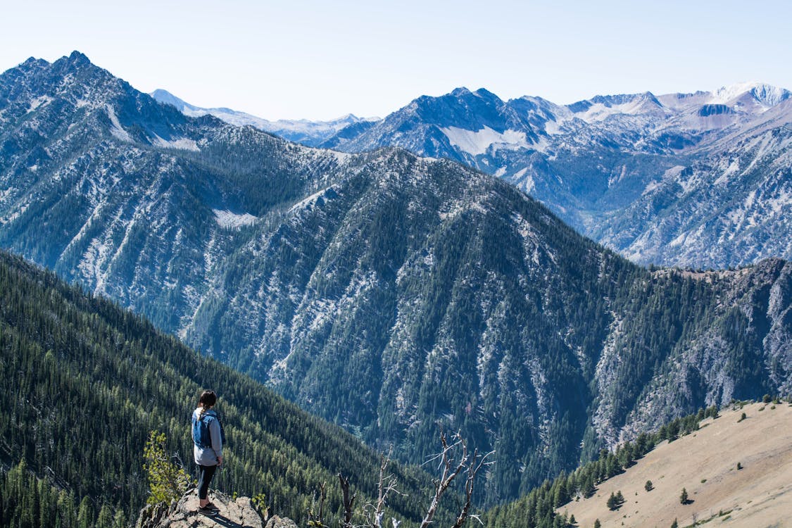 Person Standing on Cliff Watching Overview Mountain