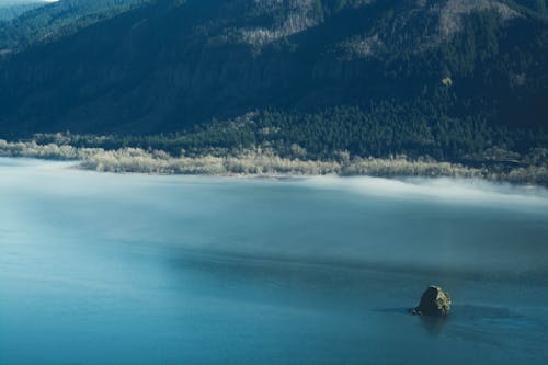 Free Green Stone in Body of Water Near Mountain Stock Photo