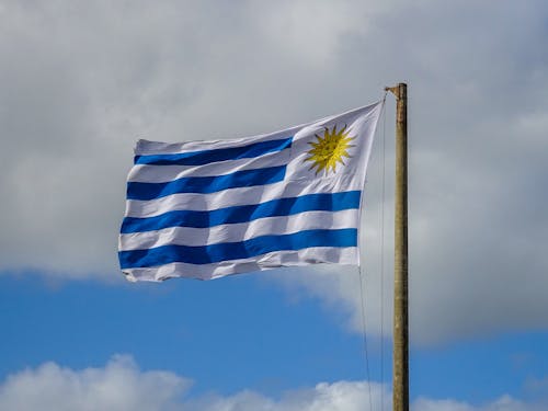The flag of uruguay is flying in the sky