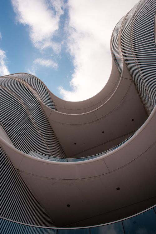 Free Explore the unique curves of innovative architecture in Cartagena against a bright blue sky. Stock Photo