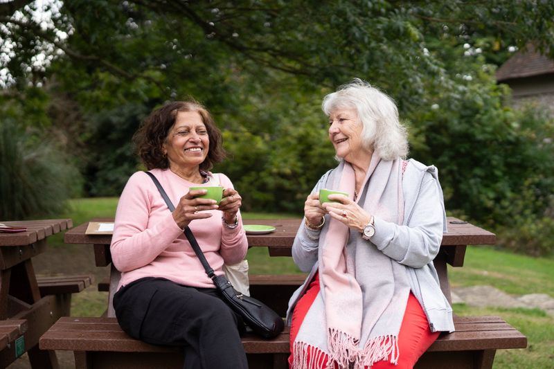 Two senior friends enjoying tea and conversation