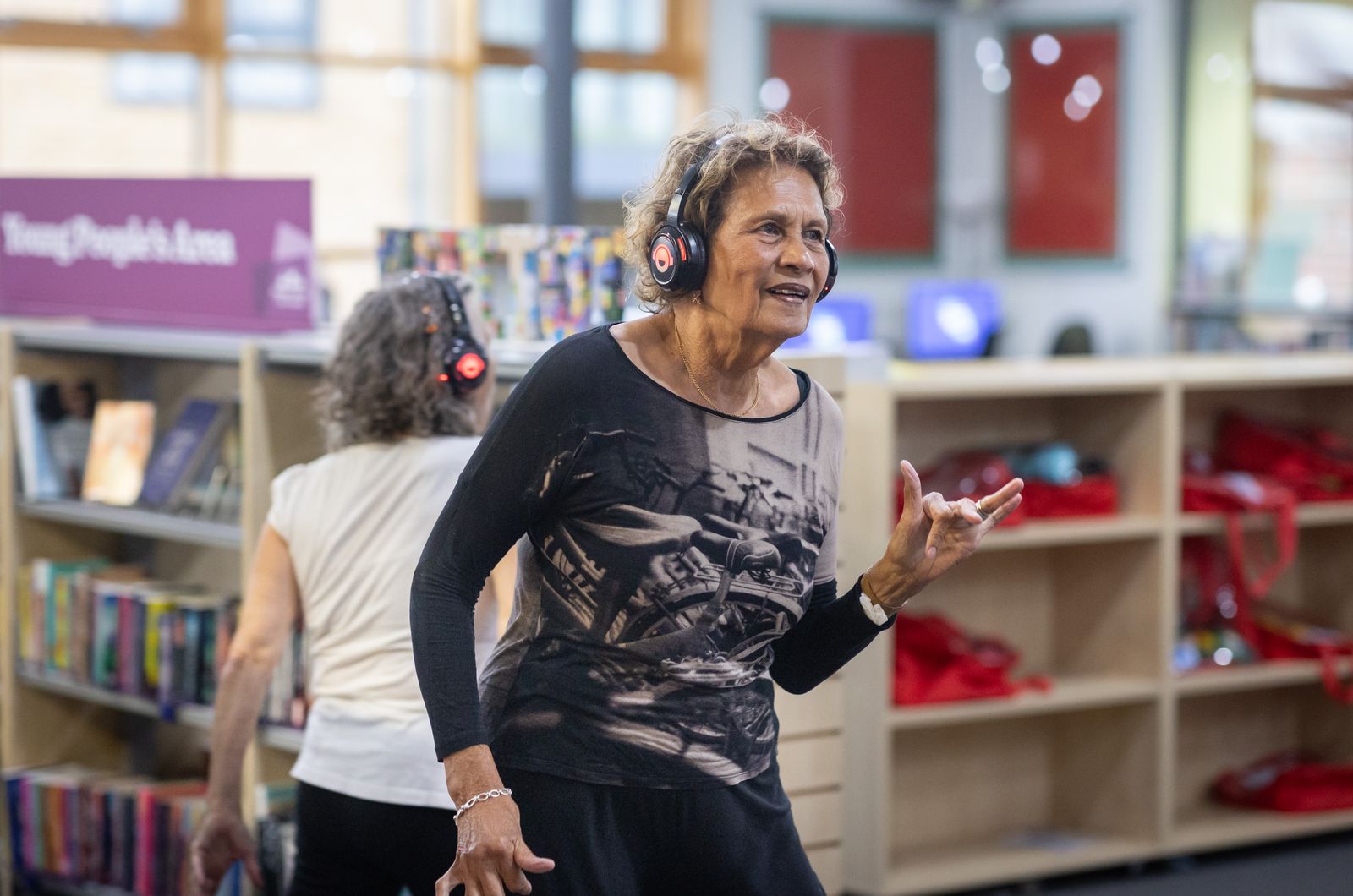 Dancers moving energetically to a global rhythm playlist during a Zumba-style class