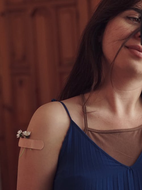 A woman with a bandage on her arm