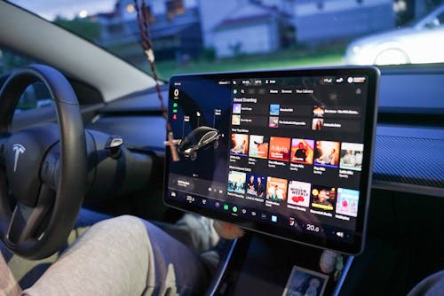 Free Close-up of a Tesla's digital dashboard showcasing entertainment options in Garešnica. Stock Photo