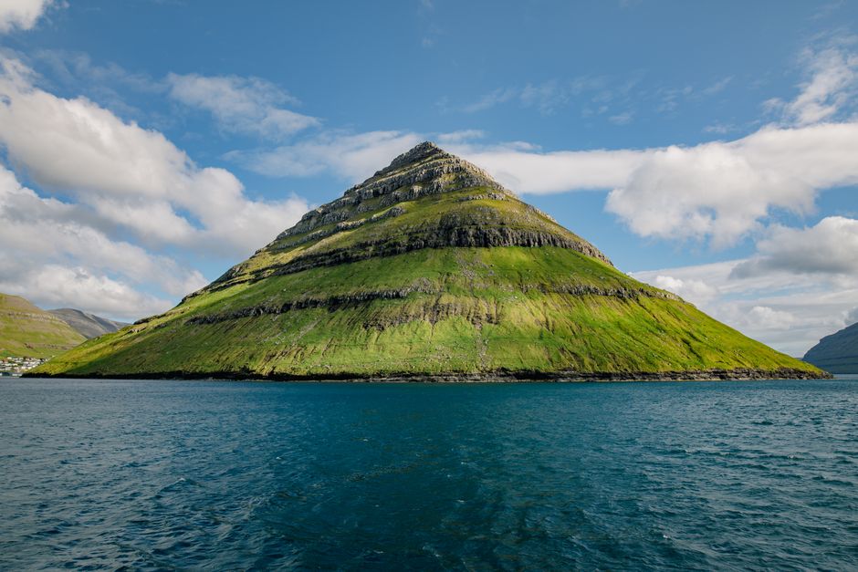 Stunning view of a mountain surrounded by the ocean in Klaksvík, Faroe Islands.