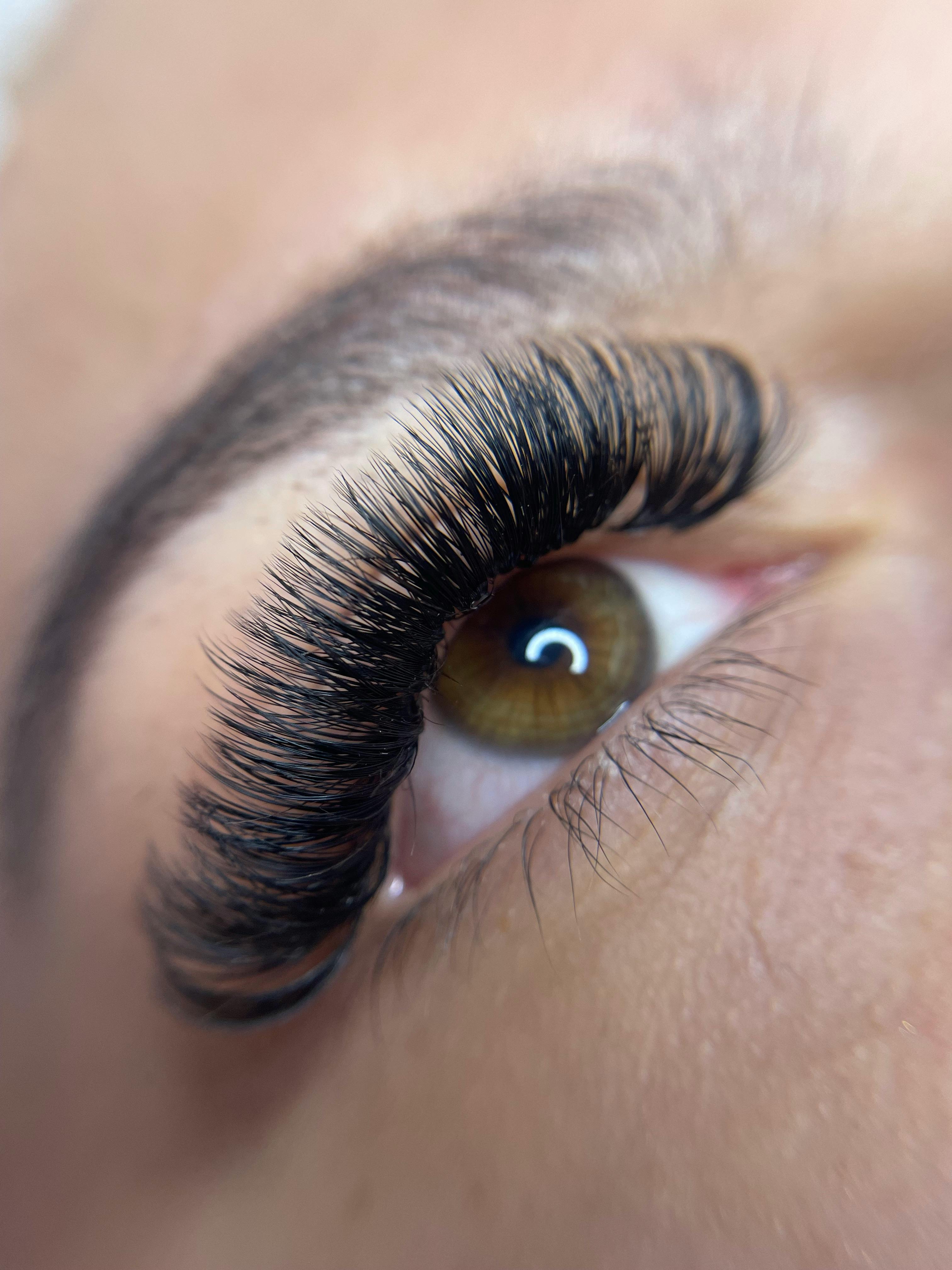 close up of an eye with glued eyelashes