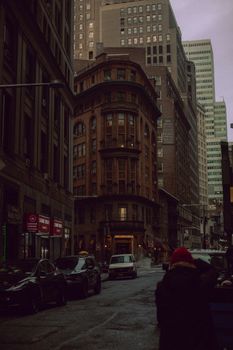 City street at dusk with cars and buildings creating a classic urban scene.