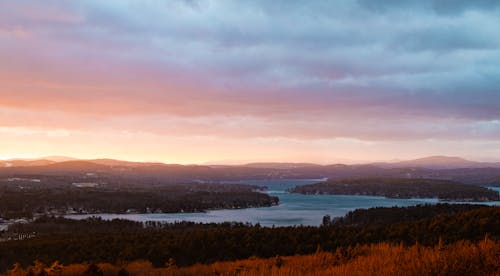 Free A sunset over a lake and hills Stock Photo