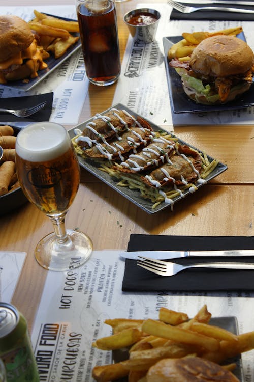 Free A table with a plate of food and a glass of beer Stock Photo