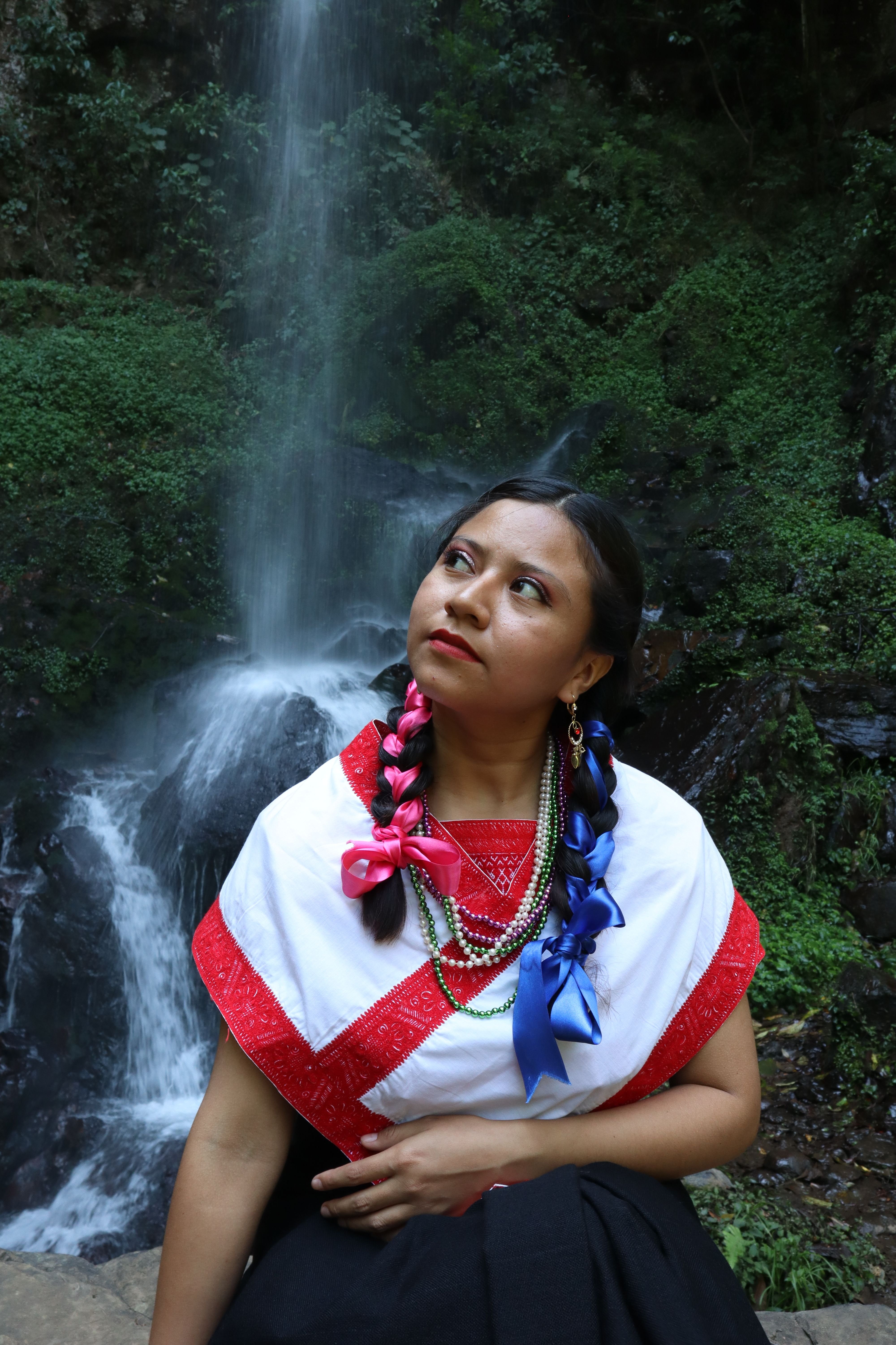 A Woman Standing by a Waterfall · Free Stock Photo