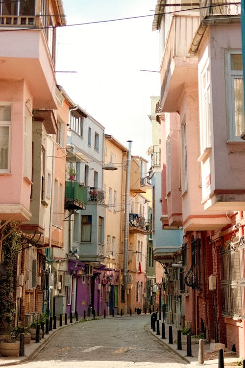 A narrow street with colorful buildings and a street sign