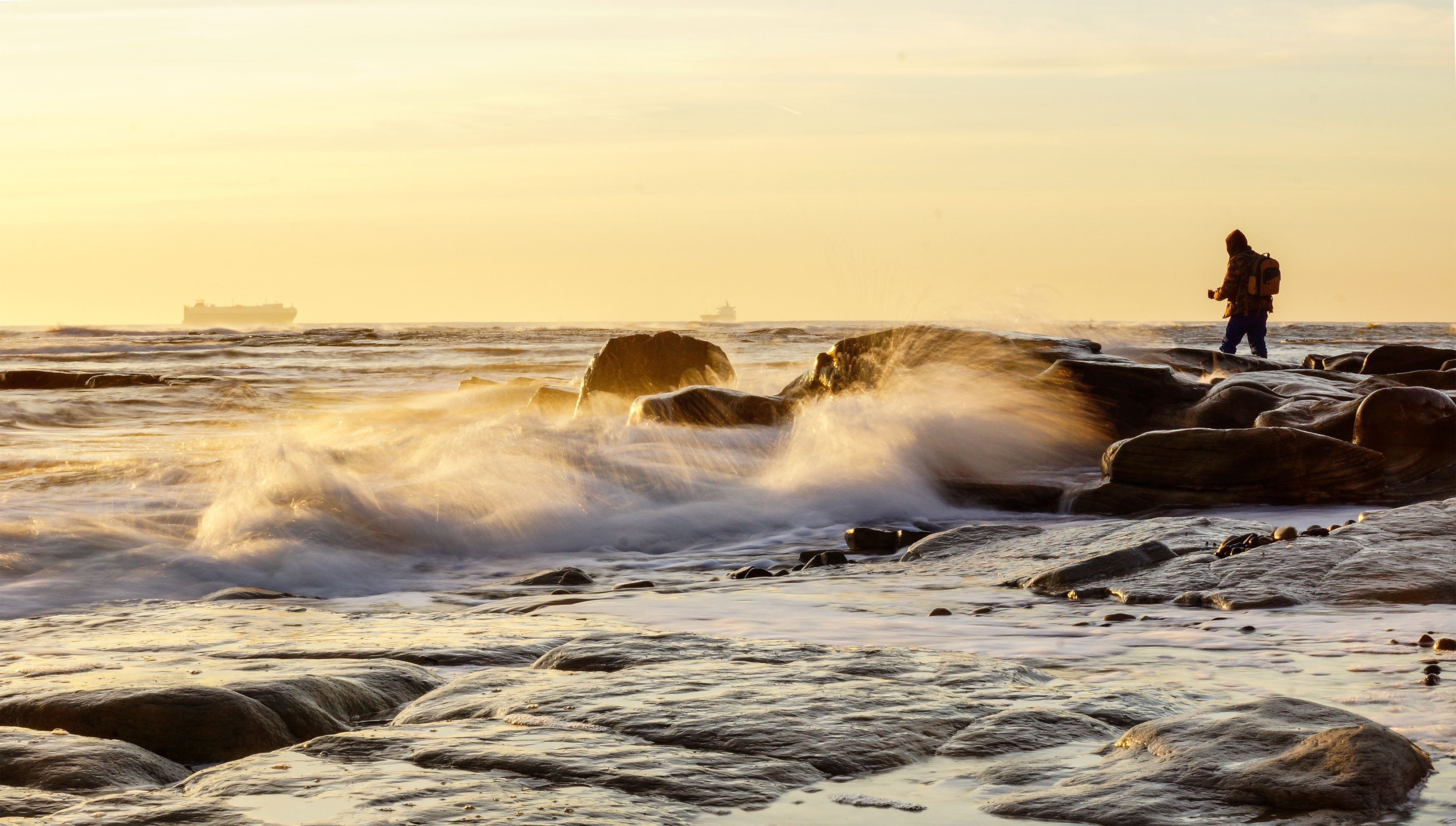 A man standing on the rocks at the ocean · Free Stock Photo