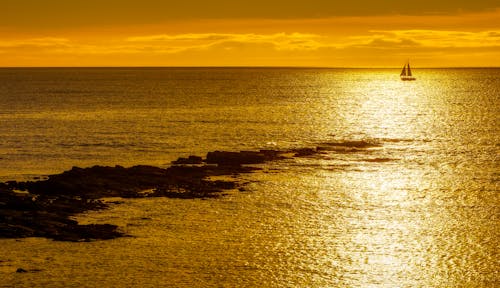 Sailboat on Sea at Sunset