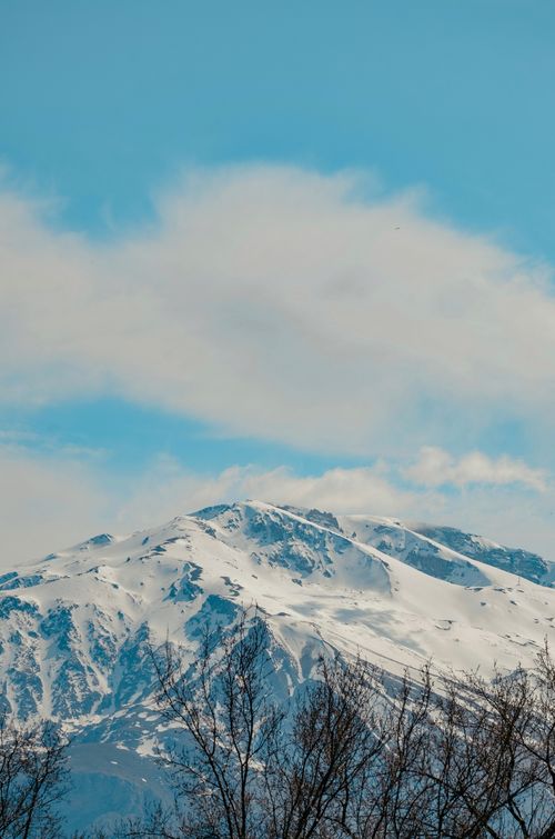 Free Stunning snow-capped mountain landscape under a clear blue sky, perfect for winter themes. Stock Photo