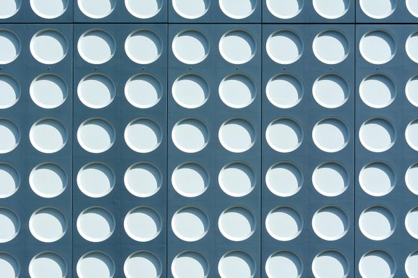 Repeating circular window facade — photo by Jan van der Wolf on Pexels