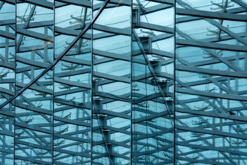 A close up of a glass building with metal structures