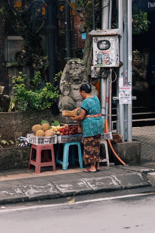 A woman selling fruit on the street