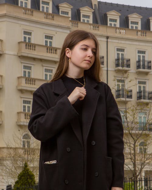 A woman in a black coat and black pants