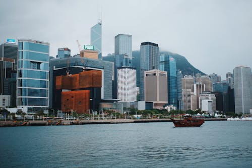 Free A boat is docked in front of a city skyline Stock Photo