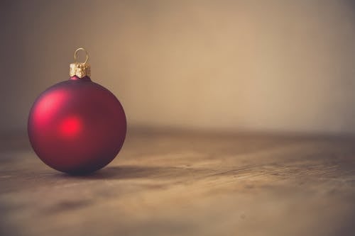 Red Bauble on Brown Sand