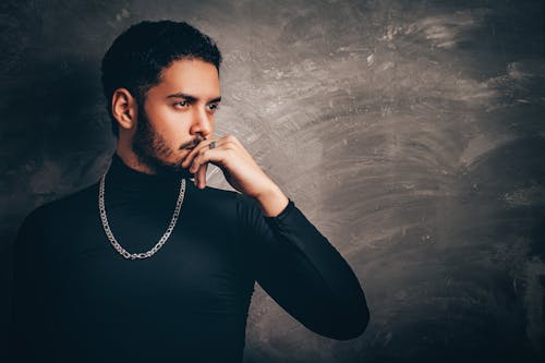 Free A man in a black shirt and necktie Stock Photo