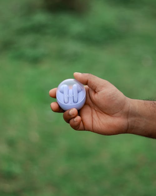 A person holding a purple ball in their hand