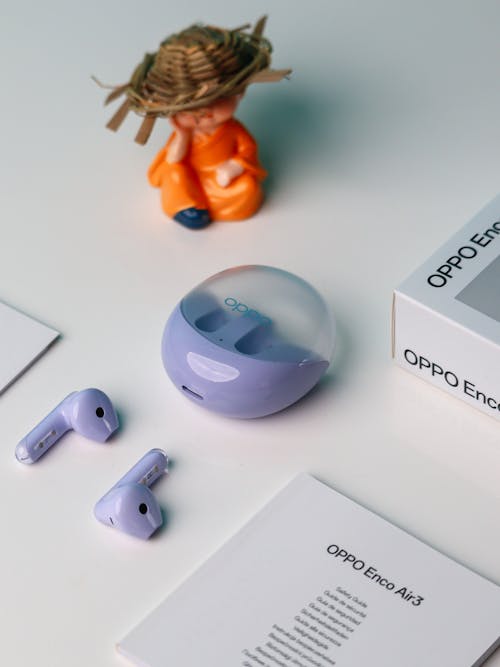 Free A purple box with a purple airpods and a figurine Stock Photo