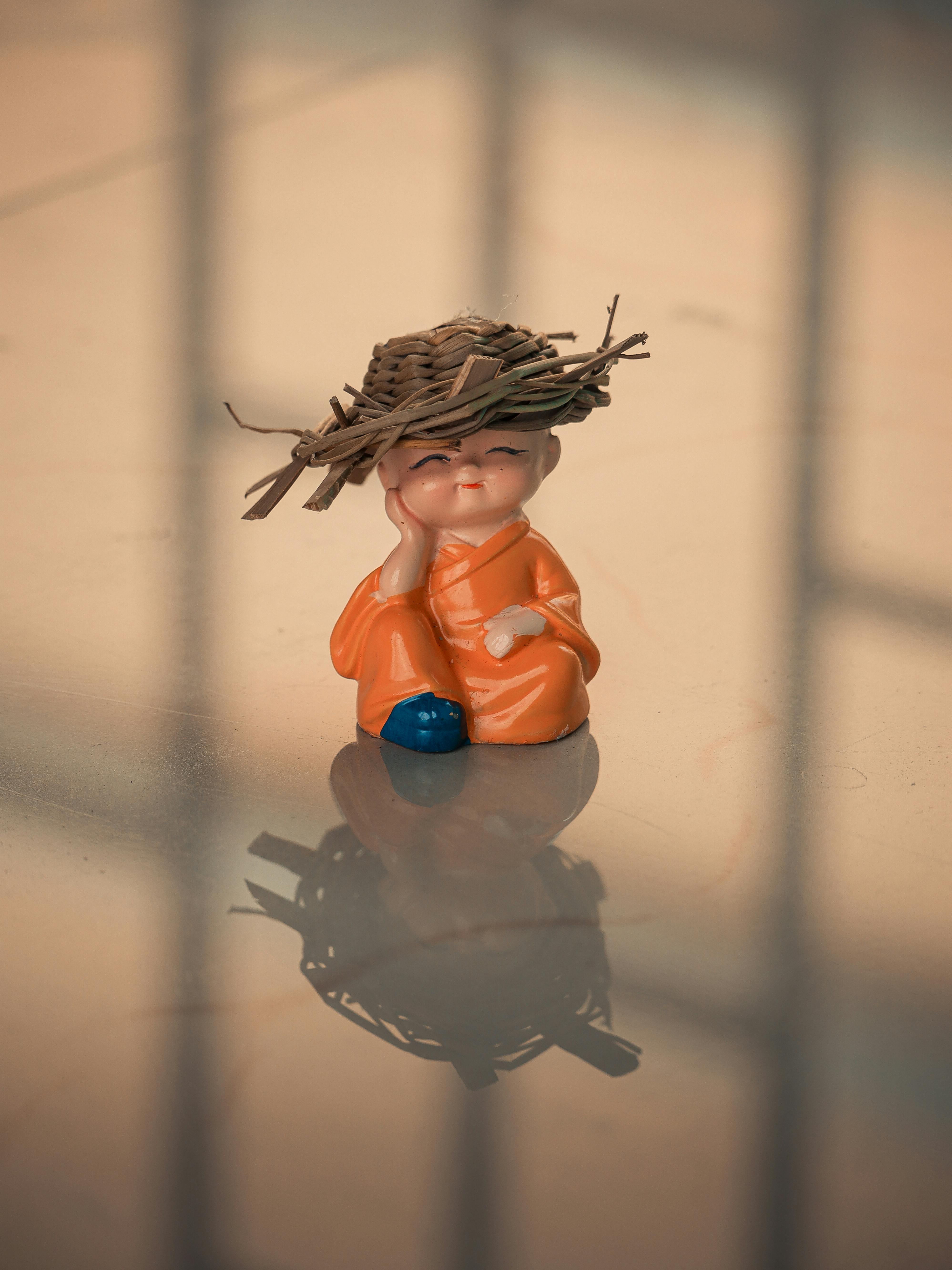 figurine of a baby with a thatched hat