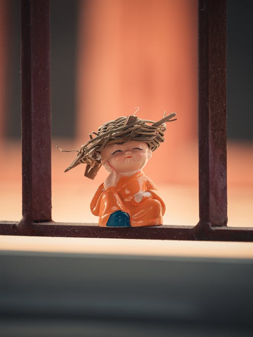 Free A small figurine of a monk with a straw hat Stock Photo