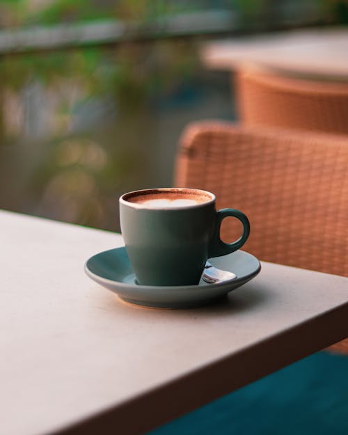 Free A cup of coffee sits on a table outside Stock Photo