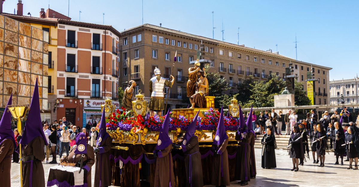 Semana Santa 2026 in Spain: Best Cities for Holy Week Processions 9 A vibrant religious procession with costumes and statues in Zaragoza, Spain.